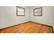 This bedroom features gleaming hardwood floors and natural light from two windows at 1212 Woodlawn Ave, Indianapolis, IN 46203