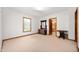 Bright bedroom featuring neutral carpet and an open doorway to the bathroom at 1212 Woodlawn Ave, Indianapolis, IN 46203