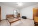 Well-lit bedroom features neutral carpet, a window, and simple wood furniture at 1212 Woodlawn Ave, Indianapolis, IN 46203