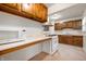 Functional kitchen with vintage wood cabinets, microwave, and gas range with hood at 1212 Woodlawn Ave, Indianapolis, IN 46203