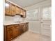 Functional kitchen features wooden cabinets, white appliances, and a practical layout at 1212 Woodlawn Ave, Indianapolis, IN 46203