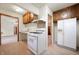 Cozy kitchen area with white stove, overhead cabinets and view to the dining room at 1212 Woodlawn Ave, Indianapolis, IN 46203