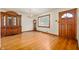 Bright living room with hardwood floors, elegant chandelier, and classic wood door at 1212 Woodlawn Ave, Indianapolis, IN 46203