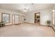 Cozy living room with front door entrance, carpet, bright windows and neutral tones at 1212 Woodlawn Ave, Indianapolis, IN 46203