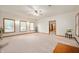 Bright, spacious living room with large windows, neutral carpeting, and ample space at 1212 Woodlawn Ave, Indianapolis, IN 46203