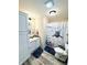 Charming bathroom with a marine-themed shower curtain and a cabinet for extra storage at 125 W Church St, Thorntown, IN 46071