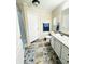 Bathroom featuring a vanity, granite countertop, and tile-look floors at 125 W Church St, Thorntown, IN 46071