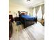 Bedroom with wood-look floors, neutral walls, and large windows providing natural light at 125 W Church St, Thorntown, IN 46071