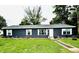 Charming single-story home showcasing blue siding, white trim, and a well-manicured lawn at 125 W Church St, Thorntown, IN 46071