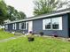 Charming single-story home showcasing blue siding, white trim, and a well-manicured lawn at 125 W Church St, Thorntown, IN 46071