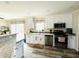 Bright kitchen featuring white cabinets, granite countertops, stainless steel appliances, and wood floors at 125 W Church St, Thorntown, IN 46071