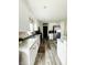 Bright kitchen with white cabinets, granite countertops, stainless steel appliances, and wood floors at 125 W Church St, Thorntown, IN 46071