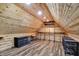 The unique, finished attic space features wood siding, laminate flooring, and metal shelving for storage at 1410 Shadow Ct, Zionsville, IN 46077