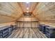The unique, finished attic space features wood siding, laminate flooring, and metal shelving for storage at 1410 Shadow Ct, Zionsville, IN 46077