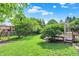 Gorgeous backyard featuring lush green grass, a play set, shade trees, and a spacious deck at 1410 Shadow Ct, Zionsville, IN 46077
