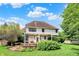 Expansive view of the home's backyard with a large deck, mature trees, and well-manicured lawn at 1410 Shadow Ct, Zionsville, IN 46077