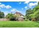 Spacious backyard with mature trees, a wooden fence, and a charming deck, perfect for outdoor living at 1410 Shadow Ct, Zionsville, IN 46077