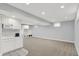 The finished basement features recessed lighting, gray walls, and a kitchenette with white cabinets at 1410 Shadow Ct, Zionsville, IN 46077