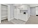 A full-sized fridge and microwave complement the white cabinets and counter in this basement kitchenette at 1410 Shadow Ct, Zionsville, IN 46077