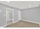View of the finished basement with neutral walls, new carpet and access to a full bathroom at 1410 Shadow Ct, Zionsville, IN 46077