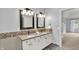 Bathroom featuring a double sink vanity with sleek countertops and decorative tile accents and stylish fixtures at 1410 Shadow Ct, Zionsville, IN 46077