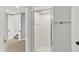 Bathroom featuring a shower with glass doors, neutral finishes, and access to other rooms at 1410 Shadow Ct, Zionsville, IN 46077