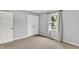 Bedroom with neutral walls, carpet and a window showing outdoor view and closet doors at 1410 Shadow Ct, Zionsville, IN 46077