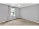 Bedroom with neutral walls, carpet and a window showing outdoor view at 1410 Shadow Ct, Zionsville, IN 46077
