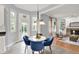 Cozy breakfast nook features a glass table, blue chairs, and large windows at 1410 Shadow Ct, Zionsville, IN 46077