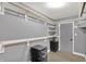 Walk-in closet with neutral colored walls and shelving system with drawers for optimal storage at 1410 Shadow Ct, Zionsville, IN 46077