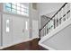 Bright foyer featuring a grand staircase, beautiful flooring and a transom window at 1410 Shadow Ct, Zionsville, IN 46077