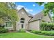Charming brick home featuring arched entryway, manicured lawn and mature trees at 1410 Shadow Ct, Zionsville, IN 46077
