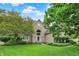 Charming brick home featuring arched entryway, manicured lawn and mature trees at 1410 Shadow Ct, Zionsville, IN 46077