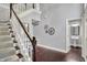 Hallway with staircase, hardwood floors, and unique wall decorations at 1410 Shadow Ct, Zionsville, IN 46077