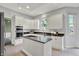 Bright kitchen boasts white cabinetry, stainless appliances, and a functional island at 1410 Shadow Ct, Zionsville, IN 46077