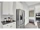 This kitchen has stainless steel refrigerator, white cabinets, and dark counters at 1410 Shadow Ct, Zionsville, IN 46077