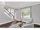 Inviting living room with dark floors, staircase, and large window at 1410 Shadow Ct, Zionsville, IN 46077