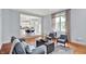 Open-concept living room with hardwood floors flowing into a modern kitchen at 1410 Shadow Ct, Zionsville, IN 46077