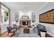 Inviting living room featuring a brick fireplace, built-in shelves, and comfortable seating at 1410 Shadow Ct, Zionsville, IN 46077