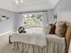 Bright and airy main bedroom with a tray on the bed and large windows at 1410 Shadow Ct, Zionsville, IN 46077