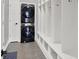 Convenient mud room with built-in lockers and modern stacked washer and dryer at 1410 Shadow Ct, Zionsville, IN 46077