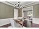 Comfortable office space features wainscoting, modern lighting, and a wooden desk at 1410 Shadow Ct, Zionsville, IN 46077