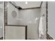 A modern bathroom featuring a walk-in shower with sleek gray tile, a shower head and decorative accent tiles at 1410 Shadow Ct, Zionsville, IN 46077