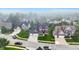 An aerial view of a residential neighborhood featuring well-maintained homes and green lawns on a foggy day at 15023 Glenmoor Cir, Carmel, IN 46033