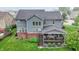 An aerial perspective of a home highlighting the covered back deck, manicured lawn, and outdoor living space at 15023 Glenmoor Cir, Carmel, IN 46033