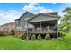 Backyard view showcasing a well-maintained lawn, wooden deck, and the home's exterior at 15023 Glenmoor Cir, Carmel, IN 46033