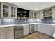 Stylish bar area with light gray cabinetry, stainless steel appliances, and a beverage tap at 15023 Glenmoor Cir, Carmel, IN 46033