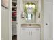 This is a stylish bathroom with white cabinets, a modern sink, and a hanging plant at 15023 Glenmoor Cir, Carmel, IN 46033