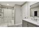 Bathroom with a glass-enclosed shower, gray vanity with marble countertop, and modern fixtures at 15023 Glenmoor Cir, Carmel, IN 46033