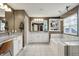 Bright bathroom features a double vanity, soaking tub, glass shower, and white tiled flooring at 15023 Glenmoor Cir, Carmel, IN 46033